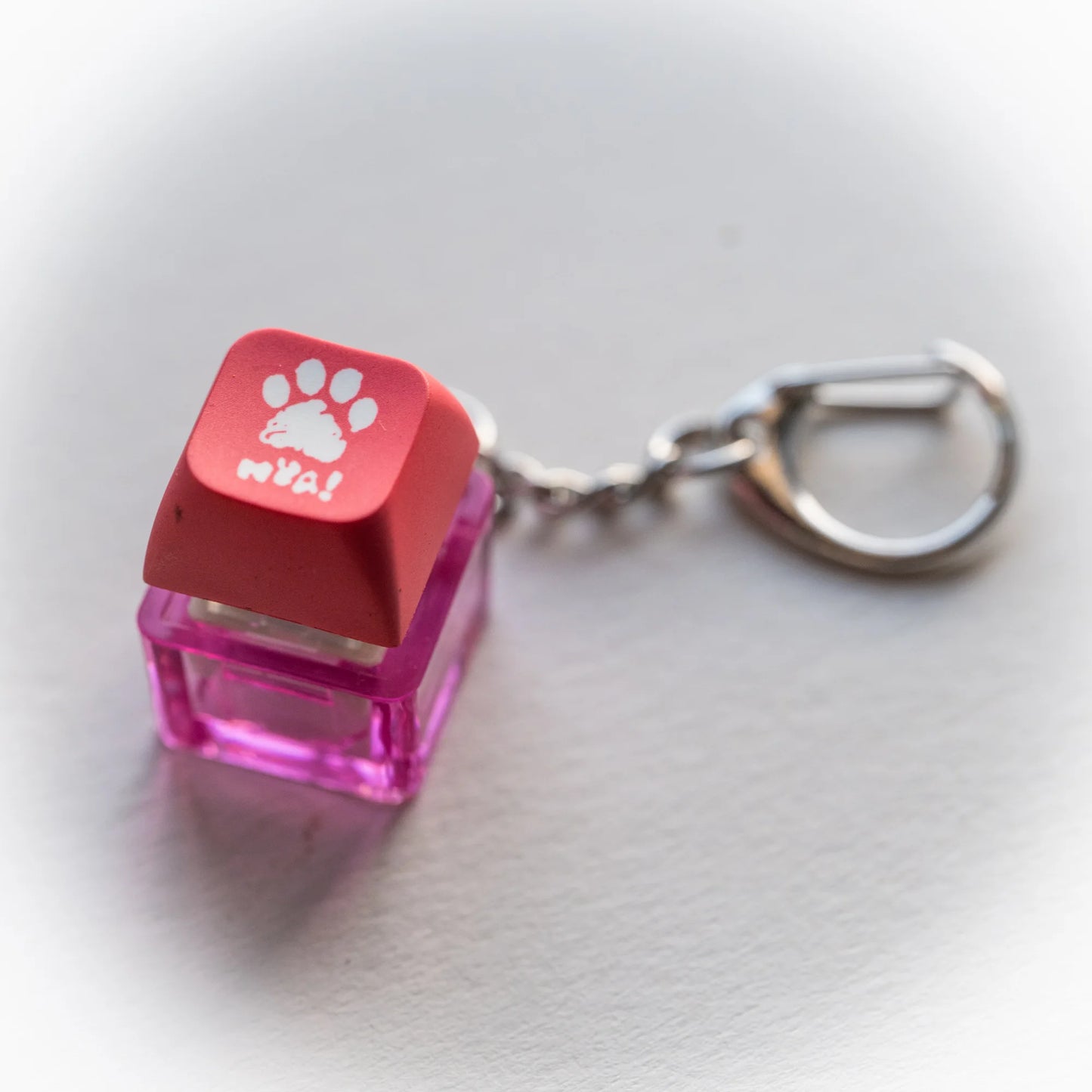 Nya Pink Clicky Keychain - pressable pink paw keyboard-key fidget toy by PlayGay