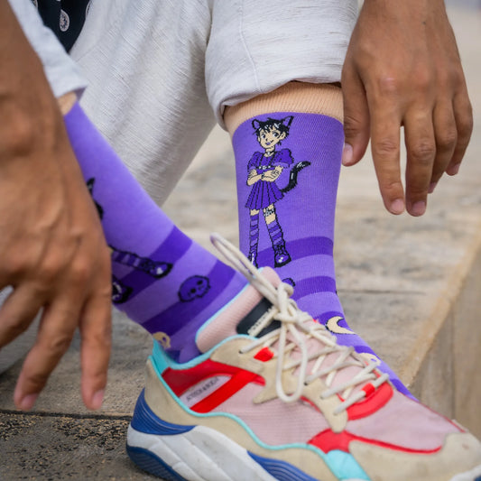 Close-up of person wearing purple socks with anime-style goth catboy in maid dress, paired with colorful sneakers.