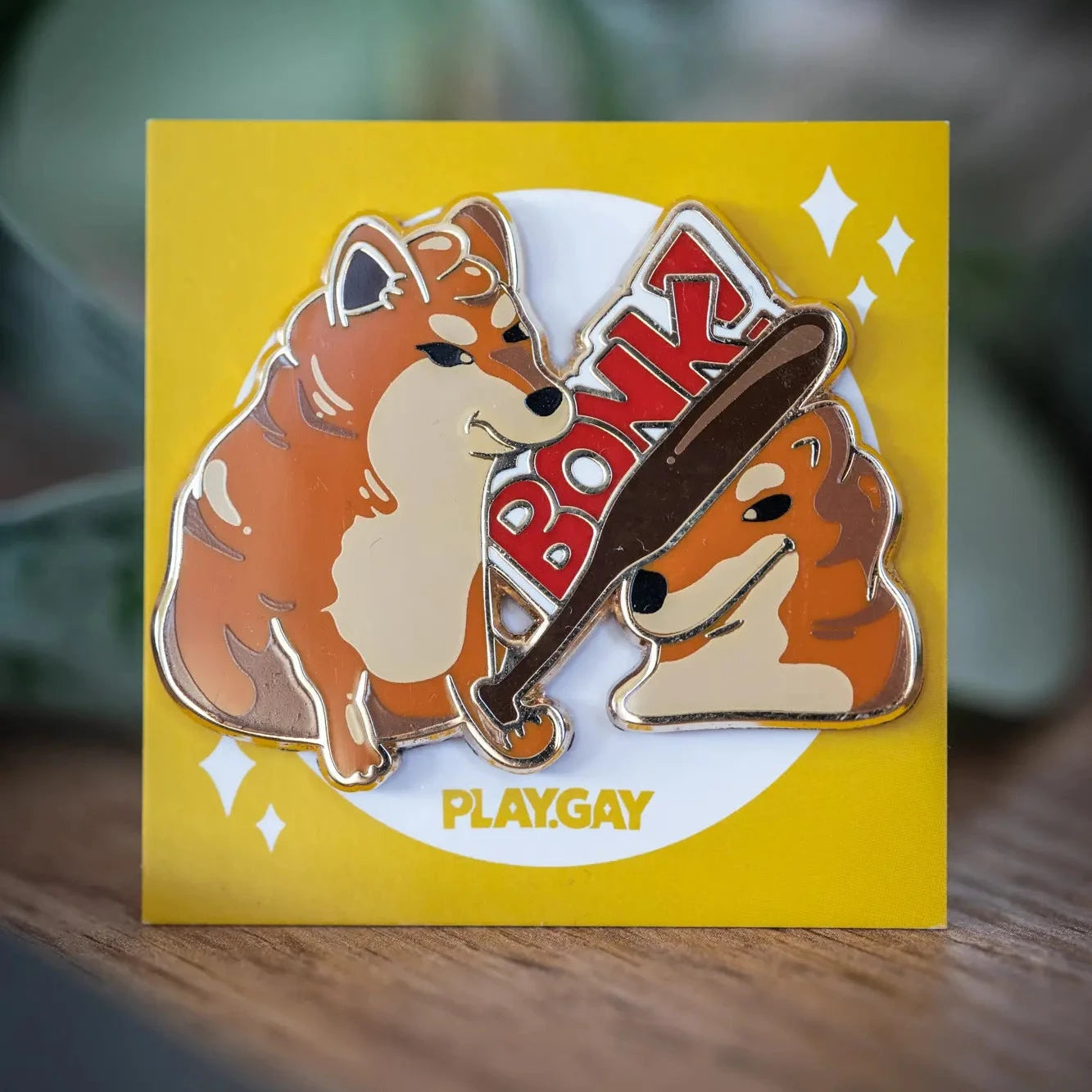 PlayGay Bonk Enamel Pin - two dogs, one bonking the other with a bat, meme-inspired hard enamel pin on yellow backing card