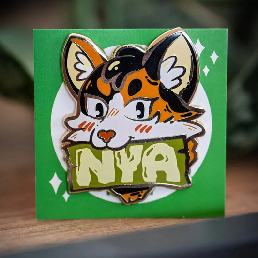 PlayGay Nya Cat (Green) Enamel Pin - calico cat with NYA banner in olive green, hard enamel on green backing card