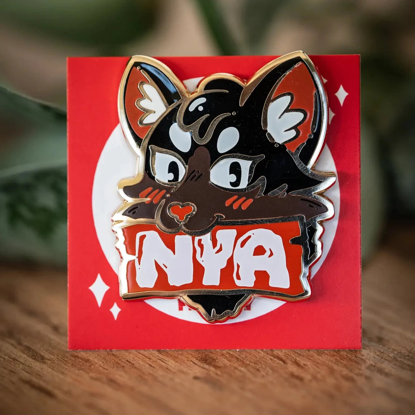 PlayGay Nya Cat (Red) Enamel Pin – black cat with bold NYA banner in red and white, hard enamel on red backing card