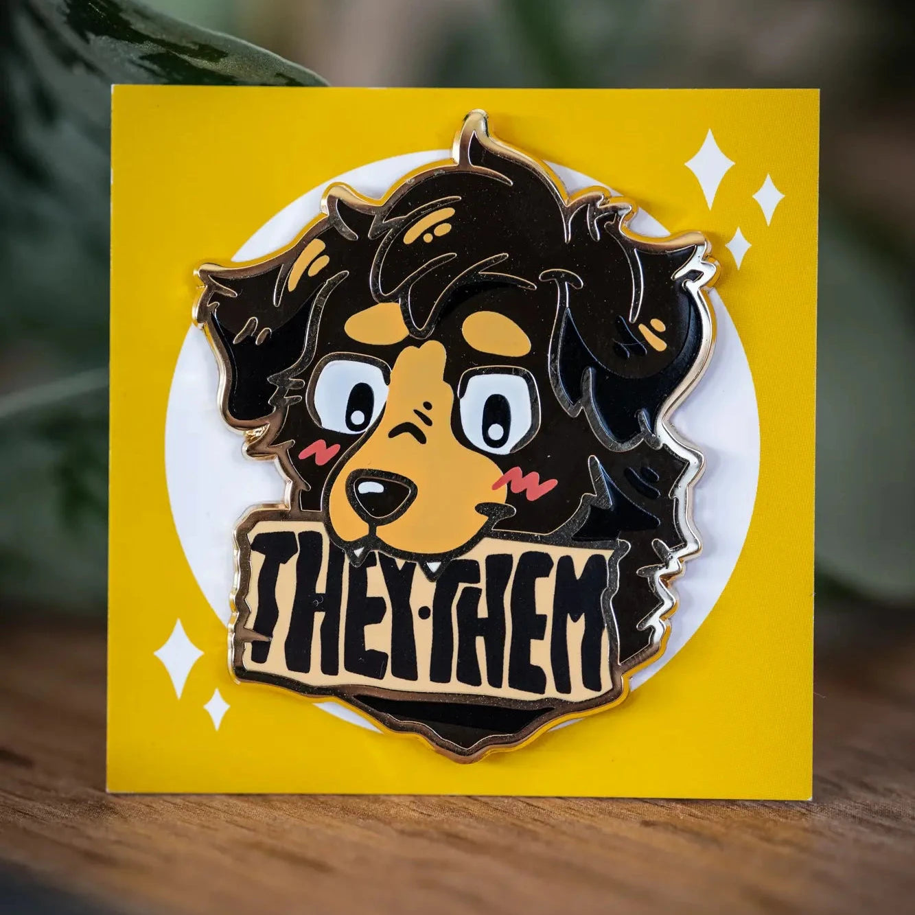 PlayGay Pronoun Dogs THEY·THEM Enamel Pin - black fluffy dog with THEY·THEM banner enamel pin on yellow backing card