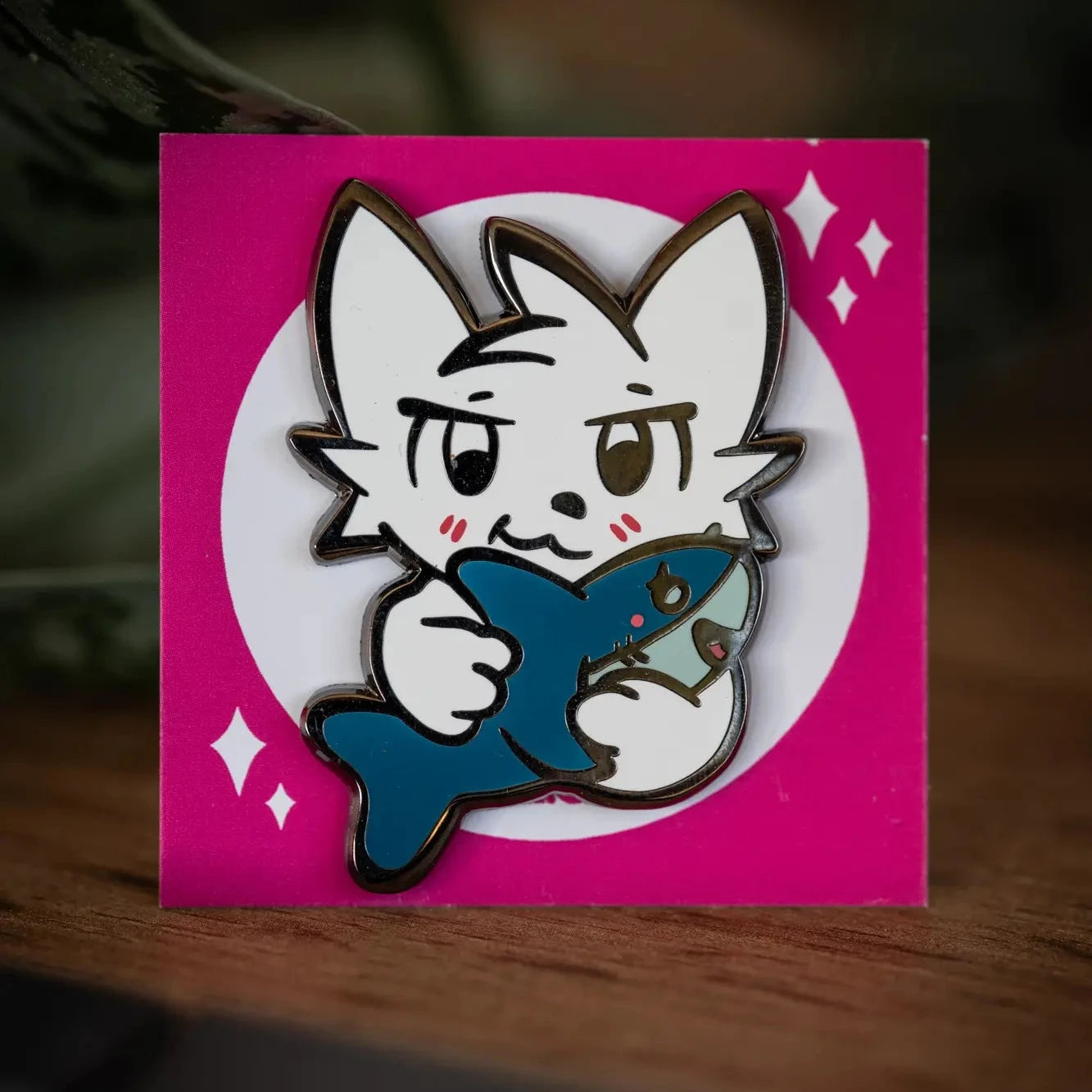 PlayGay Shark Kisser Enamel Pin – white Boykisser hugging a blue shark on pink backing card.