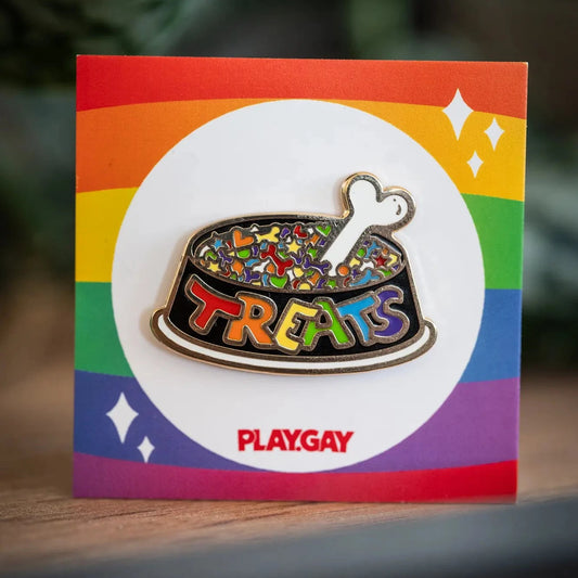 PlayGay Treats Bowl Enamel Pin - rainbow dog bowl filled with pride-coloured treats and bone on rainbow backing card